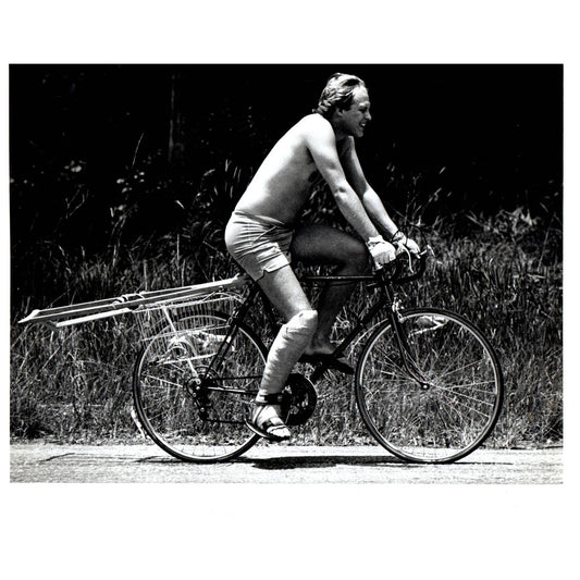 1982 Press Photo Shirtless Man Short Shorts Riding Bike on Crutches 8x10" AD3