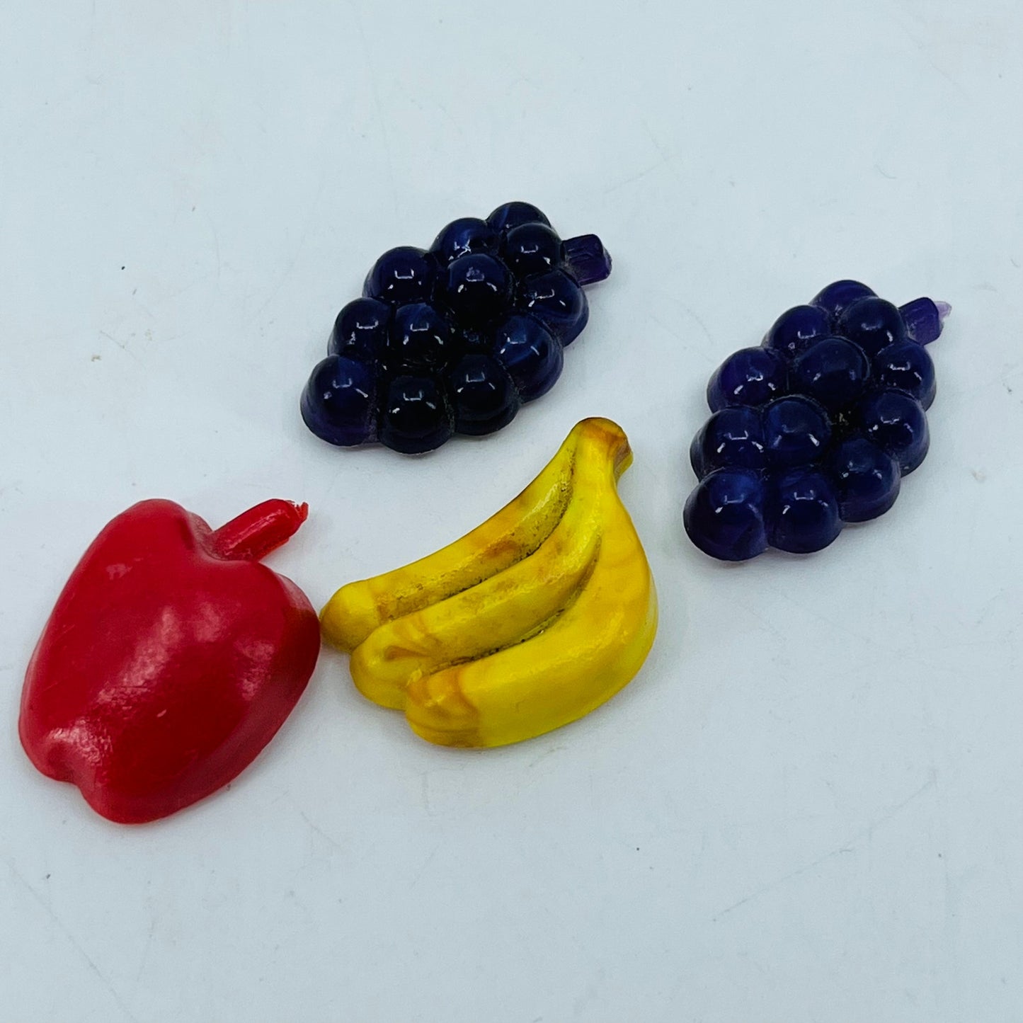Vintage Lot of 4 Miniature Celluloid Fruit Grapes Banana Apple Magnets 1” SB2